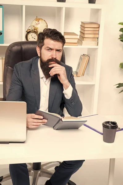 Business literature. Boss read book. Reading authority business book. Man bearded hipster boss sit armchair office interior read book. Boss at workplace. Guy formal clothing corporate style working