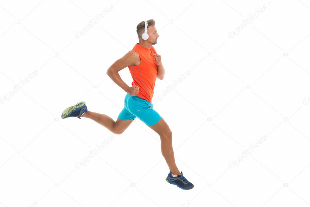 Feel the rhythm. Motivational song. Man sportsman running with headphones. Runner handsome strong guy motion isolated on white. Music for workout training. Run faster. Running sport. Keep running