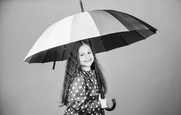 Cheerful hipster child in positive mood. rain protection. Rainbow. happy little girl with colorful umbrella. little girl in raincoat. autumn fashion. Happiness highlights her beauty — Stock Photo, Image