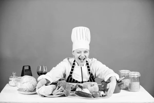 Woman chef wear hat apron near table ingredients. Girl adorable chef teach culinary. Best culinary recipes to try at home. Homemade food tips. Turn ingredients into delicious meal. Culinary skills