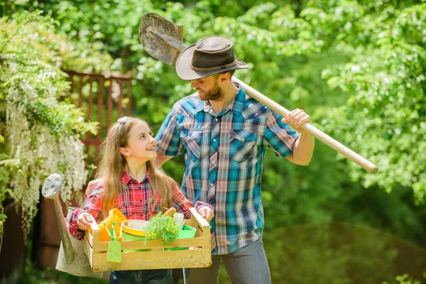 family farm. summer farm. spring village country. ecology. Gardening tools. little girl and happy man dad. earth day. daughter and father on ranch. Like what you do