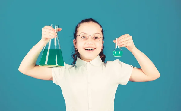 Schoolgirl with chemical liquids. Childhood and upbringing. Knowledge and information. Experimenting a bit. Small kid study. Education concept. Chemistry fun. Basic knowledge. Knowledge day