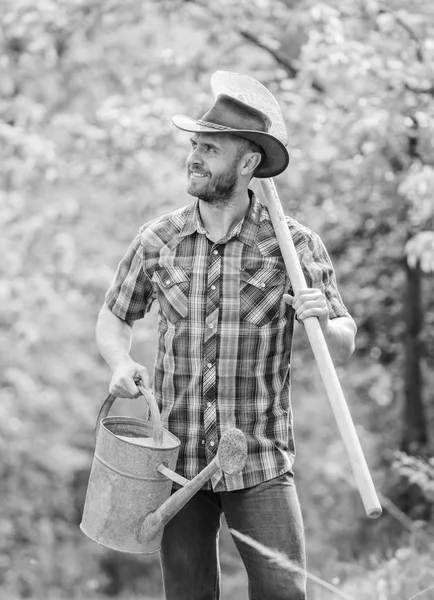 Farming and agriculture cultivation. Garden equipment. Eco farm. Harvest. muscular ranch man in cowboy hat. happy earth day. Eco living. sexy farmer hold shovel and watering can. Like what you do — Stock Photo, Image