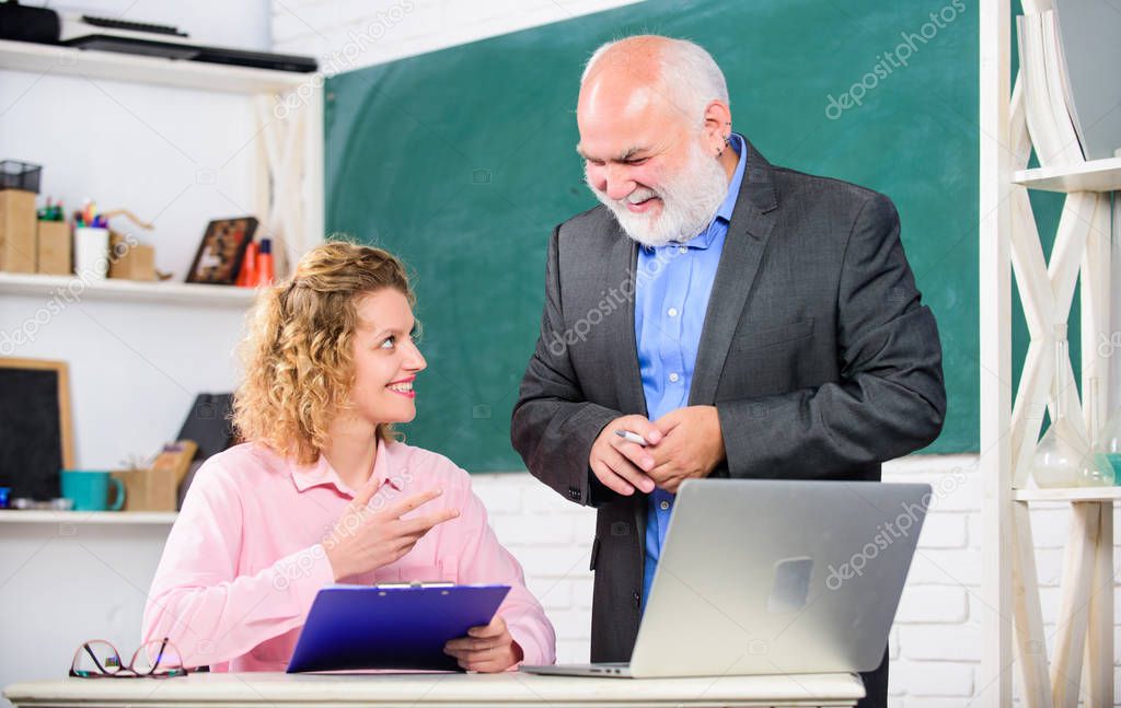 Attention. pass exam. teachers room. senior teacher and woman at school lesson. student and tutor with laptop. brainstorming on new project working. happy student girl with tutor man at blackboard