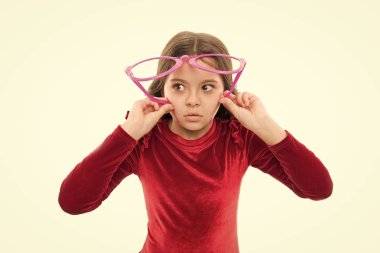 Görme ve göz sağlığı. Görme yeteneği geliştirmek. Kız çocuk giyim büyük gözlük izole beyaz arka plan. Optik ve görme tedavisi. Yakınlaştırma etkili egzersiz gözler. Çocuk iyi görme yeteneği ile mutlu