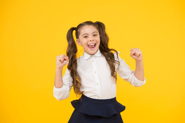 Celebrate knowledge day. Girl pupil on yellow background. Back to school. Student little kid. Emotional school girl. Successful graduation. Happy childrens day. Positive vibes. School life concept