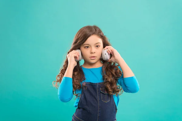 Everything but music. Little girl enjoying her favorite music on blue background. Small child listening to music. Adorable kid wearing stylish headphones playing music — Stock Photo, Image