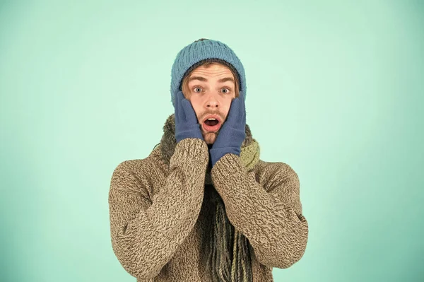 Man wear knitted accessory turquoise background. Winter accessories concept. Winter fashion knitted clothes. Knitted accessories as hat and scarf. Man knitted hat gloves and scarf winter fashion