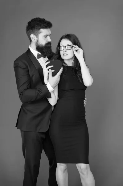 tuxedo man and woman at formal party. valentines day heart. bearded businessman with lady. sexy couple in love. tuxedo formal couple. business meeting. love date. tuxedo bow tie. love is in the air