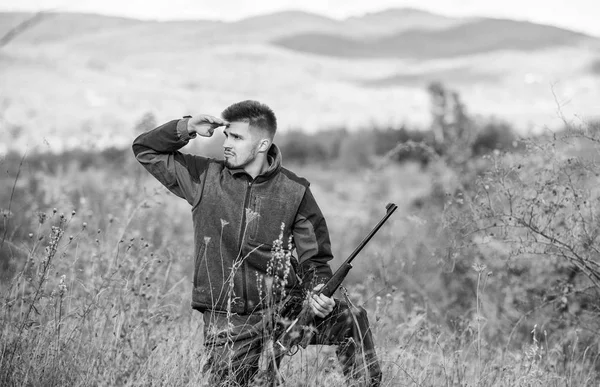 Hunter hold rifle. Focus and concentration of experienced hunter. Hunting and trapping seasons. Man brutal gamekeeper nature background. Hunting permit. Bearded hunter spend leisure hunting