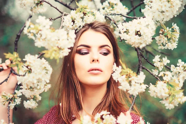 Girl in harmony with nature. Natural environment organic cosmetics. Spring freshness. Natural cosmetics concept. Makeup skin care. Blooming trees flowers. Natural beauty. Pretty woman skincare