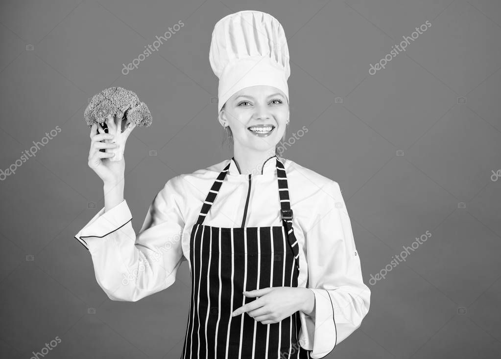 Including healthy organic foods in your life. Happy woman chef holding natural cabbage for healthy diet. Lady cook smiling with healthy green broccoli in hand. For a truly healthy and enjoyable dish