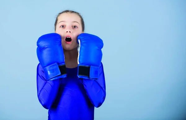 With great power comes great responsibility. Boxer child in boxing gloves. Female boxer change attitudes within sport. Risk of injury. Rise of women boxers. Girl cute boxer on blue background — Stock Photo, Image