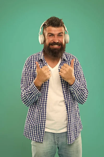 Music library concept. Tech gadgets all music lovers should have. Music always with me. Man listening song in headphones. Best gifts for music lovers. Bearded hipster wear headphones. Excellent sound