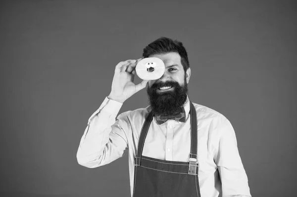 Happy baker. Kuchař muž v kavárně. Jídlo kalorií. Vousatý muž v zástěře. Kobliha potravin. Dietní a zdravé potraviny. Baker drží prstenec. Legrační bokovky. Sladká jídla. Kalorií. Pocit hladu. Jen to nejlepší — Stock fotografie