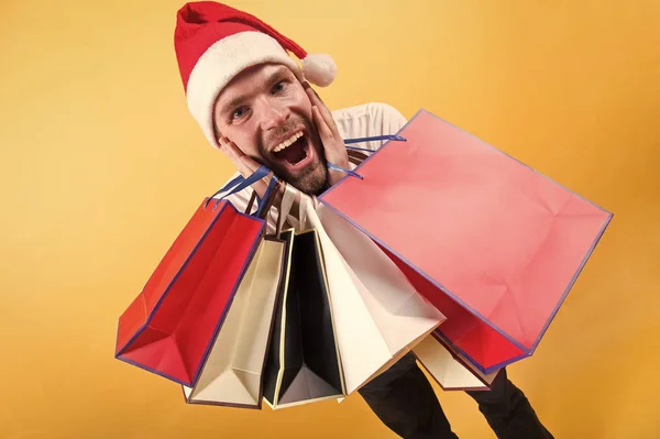 The morning before Xmas. man in santa hat hold christmas present. delivery christmas gifts. happy santa man on yellow background. online christmas shopping. Happy new year. Christmas composition — Stock Photo, Image