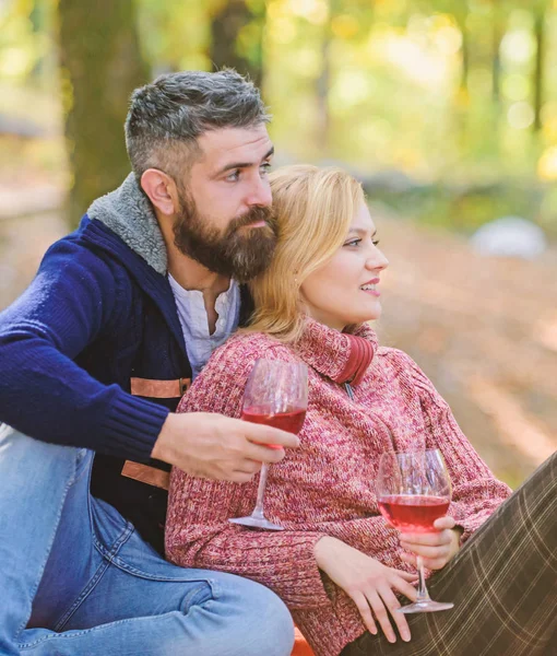 Choosing wine for dinner. love date and romance. Spring mood. happy woman and bearded man drink wine. Family picnic. cheers. Red wine in fall weather. couple in love relax in autumn forest