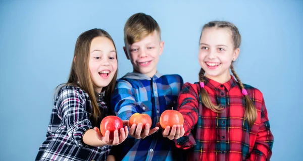 School snack time. Boy and girls friends eat apple snack. Teens with healthy snack. Apple fruit has numerous benefits. Vitamin nutrition concept. Eat fruit and be healthy. Having tasty snack