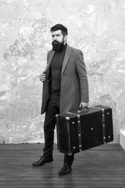 Man well groomed bearded hipster with big suitcase. Travel and baggage concept. Hipster traveler with baggage. Ready for relocation with baggage. Start journey. On way to new life. Luggage insurance