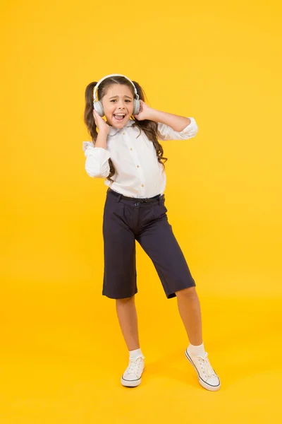 Home schooling. Small girl pupil headphones. Child happy listen music. Sing song. Audio book. Education and fun concept. Online schooling. Listening lesson. Child enjoy music sound. Audio schooling — Stock Photo, Image