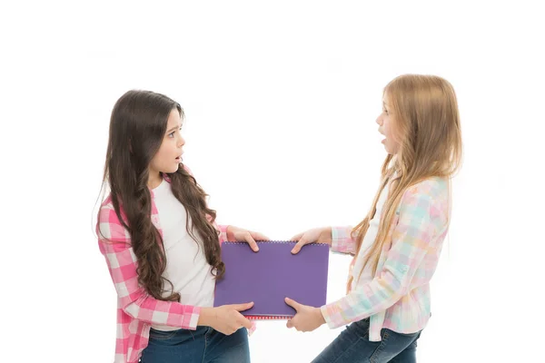 They need help with homework. Naughty schoolgirls in school homework club. Little school children fighting over homework assignment. Small pupils cant share homework diary and record book among them — Stock Photo, Image