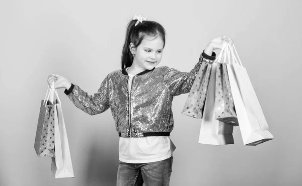 Why not. Cheerful child. Little girl with gifts. Mall. Sales and discounts. store retail. Holiday purchase saving. Fashion and style. customer with package. Small girl with shopping bags