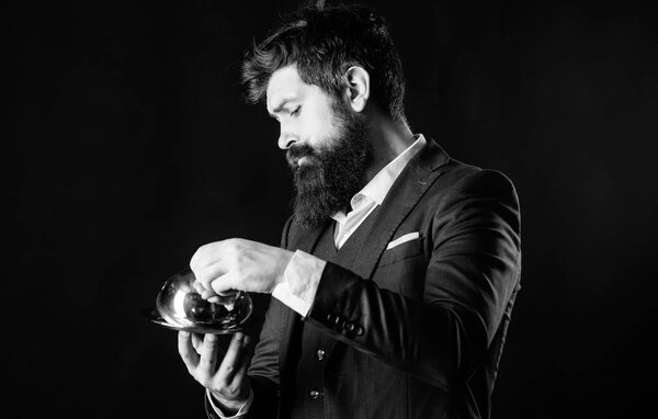 Waiter luxury restaurant. Man well groomed gentleman formal suit hold little cloche. Serving and presentation. Elite luxurious. Secret under cloche. Exclusive food hidden cloche. What is under cloche