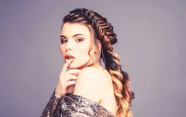 French braid. Professional hair care and creating hairstyle. Braided hairstyle. Beautiful young woman with modern hairstyle. Beauty salon hairdresser art. Girl makeup face braided long hair