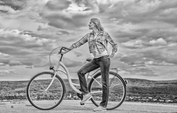 Girl ride cruiser bicycle. Health benefits of cycling. Reasons to ride bike. Woman rides bicycle sky background. Increase muscle strength and flexibility by riding bike. Benefits of cycling every day