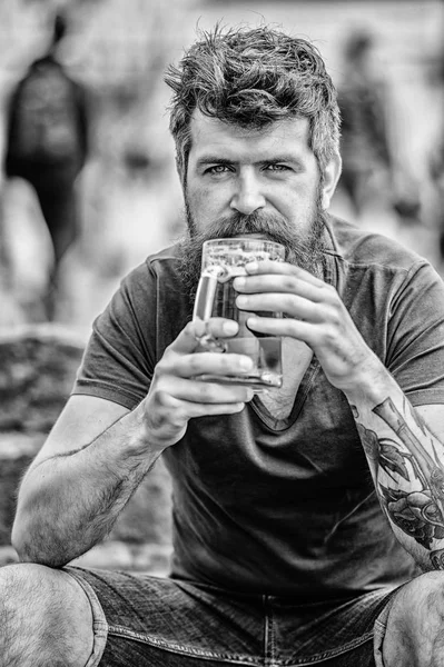 Guy having rest with cold draught beer. Hipster relaxed drinking beer outdoor. Light ales or dark stouts drink them all. Man with beard and mustache hold beer glass outdoors. Cafe summer terrace — Stock Photo, Image