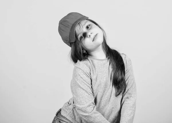 Menina vestindo boné de beisebol brilhante. Moda moderna. Moda infantil. Um acessório elegante. Sentindo-se confiante com este boné. Cutie em boné. Menina bonito criança desgaste chapéu ou snapback chapéu bege fundo — Fotografia de Stock