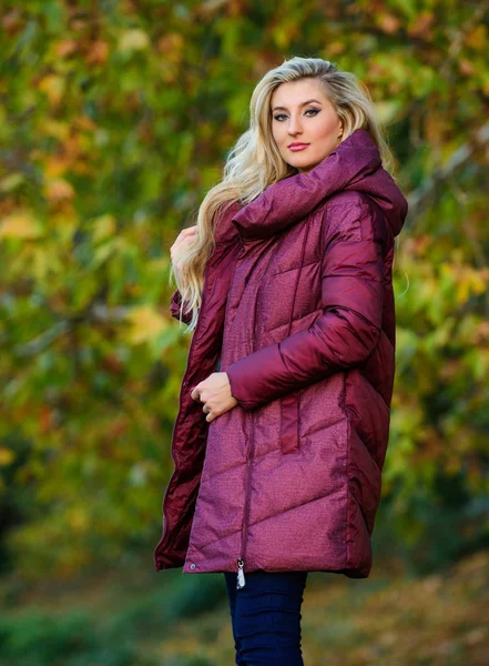 Girl fashionable blonde walk in autumn park. Jackets everyone should have. Best puffer coat to buy. How pick puffer jacket. Puffer fashion concept. Professional stylist advice. Woman wear warm jacket
