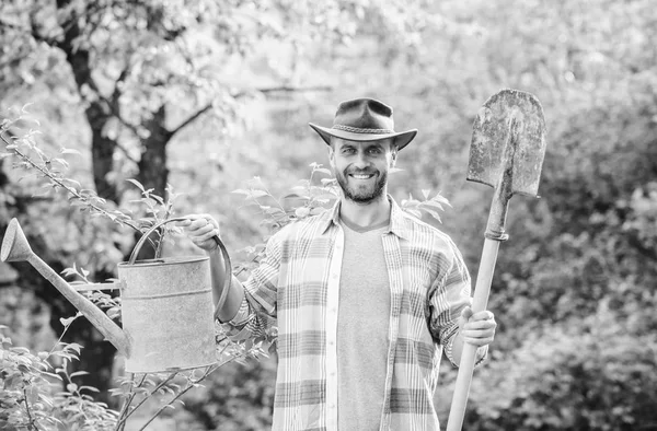 Happy earth day. Eco living. Eco farm. Harvest. sexy farmer hold shovel and watering can. farming and agriculture. Garden equipment. muscular ranch man in cowboy hat. Taking good care of plants — Stock Photo, Image