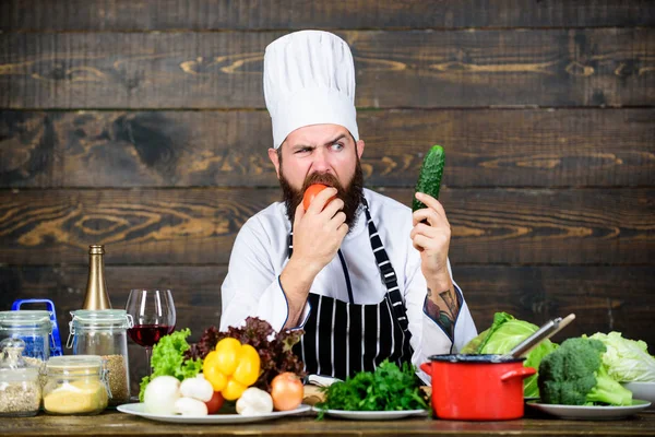 Juicy and sweet. Vitamin. man use kitchenware. Dieting with organic food. Fresh vegetables. unhappy bearded man cooking in kitchen. Professional chef in cook uniform. Healthy food and vegetarian