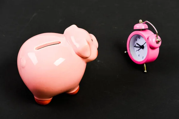 time of poverty. time is money. Economy and budget increase. piggy bank with alarm clock. Moneybox. business startup. financial position. success in finance and commerce. retirement. family budget