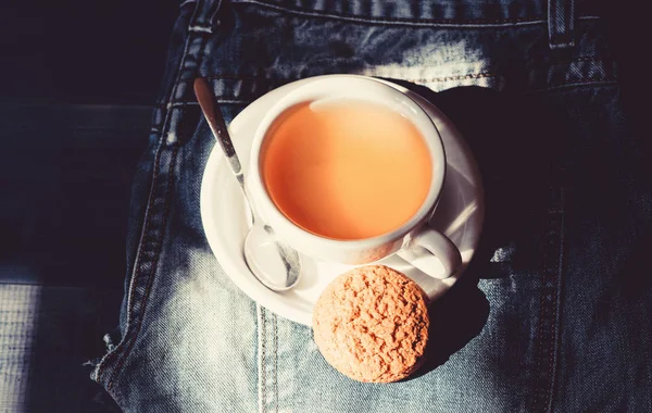 Quick snack concept. Relaxing chamomile tea. Cup mug hot tea and oat cookie. Mug filled tea close up. Herbal green or black whole leaf. Process tea brewing ceramic mug. Inspiration and peaceful mood