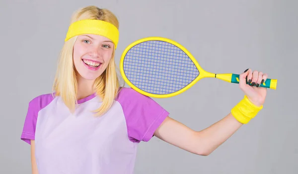 Girl adorable blonde play tennis. Sport for maintaining health. Active leisure and hobby. Athlete hold tennis racket in hand on grey background. Tennis sport and entertainment. Tennis club concept — Stock Photo, Image