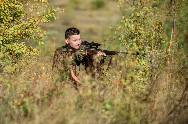 Hunting permit. Hunting is brutal masculine hobby. Hunting equipment for professionals. Bearded serious hunter spend leisure hunting. Hunter hold rifle. Man wear camouflage clothes nature background — Stock Photo, Image