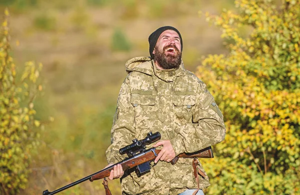Man brutal gamekeeper nature background. Regulation of hunting. Hunter hold rifle. Bearded hunter spend leisure hunting. Focus and concentration of experienced hunter. Hunting masculine hobby concept