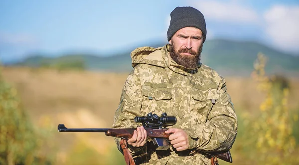 Hunting masculine hobby. Man brutal gamekeeper nature background. Bearded hunter spend leisure hunting. Hunter hold rifle. Focus and concentration of experienced hunter. Hunting and trapping seasons
