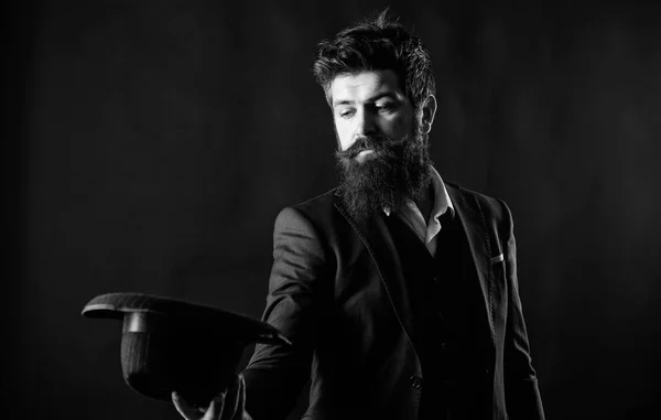 Man well groomed bearded gentleman on dark background. Male fashion and menswear. Formal suit classic style outfit. Elegant and stylish hipster. Retro fashion hat. Man with hat. Vintage fashion