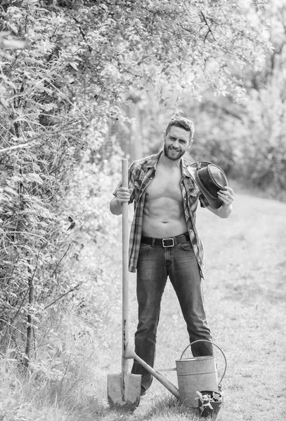 Arbor day. Planting trees. Commitment and responsibilities. Agriculture concept. Planting in garden. Tree planting tradition. Growing plants. Man handsome muscular torso with watering can and shovel — Stock Photo, Image