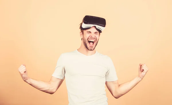 Entertainment and education. Augmented 3D world. Virtual simulation. Man play game in VR glasses. Explore cyber space. Man hipster virtual reality headset on peach background. Virtual communication — Stock Photo, Image