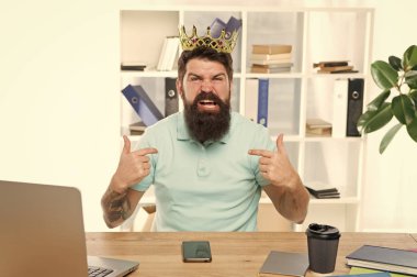 I am the best. Superiority and self confidence. King of office. Serious boss at work place. Aggressive boss shouting at you. Respect me. Man arrogant rude boss with golden crown sit in office clipart