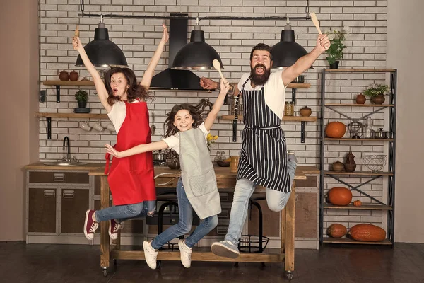 Starting day. Happy family in kitchen. Mother and father with little girl. Family day. Little girl with parents. Father, mother and child chef. Little girl study cooking. parents with little girl