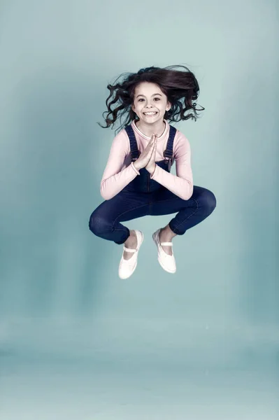 Small girl happy jump in yoga pose, energy