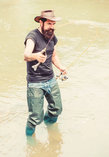 Bay Fishing Adventures. summer weekend. Fly fishing. Happy bearded fisher in water. fisherman show fishing technique use rod. hobby and sport activity. mature man fly fishing. man catching fish — Stock Photo, Image