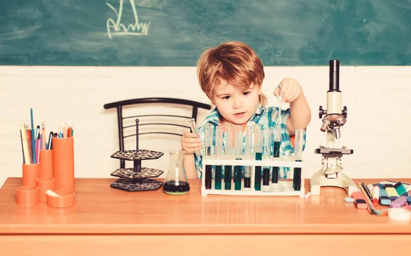 Discover liquids. Practical knowledge concept. Study grants and scholarship. Boy performing chemistry test. Wunderkind and early development. Small pupil learn chemistry school. Chemistry laboratory