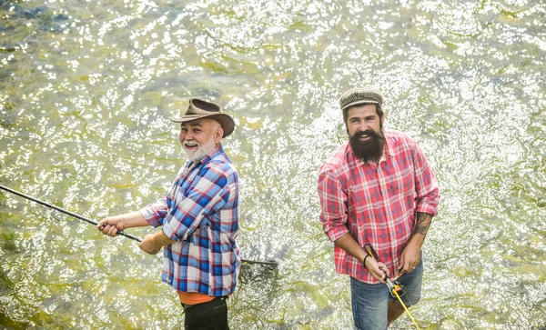 Os amigos dos pescadores estão no rio. Peixes normalmente capturados em estado selvagem. Lazer. Homens barbudos pescadores. Fins de semana feitos para pescar. Dia ensolarado ativo. Equipamentos de pesca dos pescadores. Atividades desportivas Hobby — Fotografia de Stock