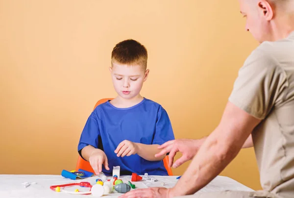 Analysis laboratory. Kid little doctor sit table medical tools. Health care. Pediatrician concept. Medical examination. Boy cute child and his father doctor. Hospital worker. Medical service — Stock Photo, Image